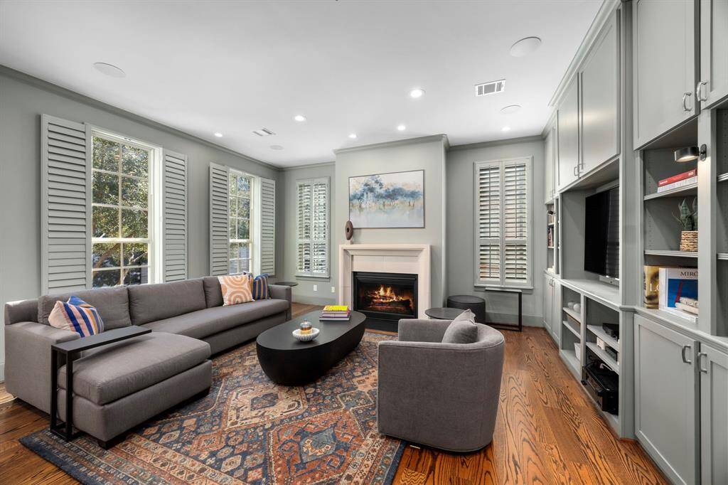 Living room in the treetops! Sleek built-in shelves and elegant fireplace.