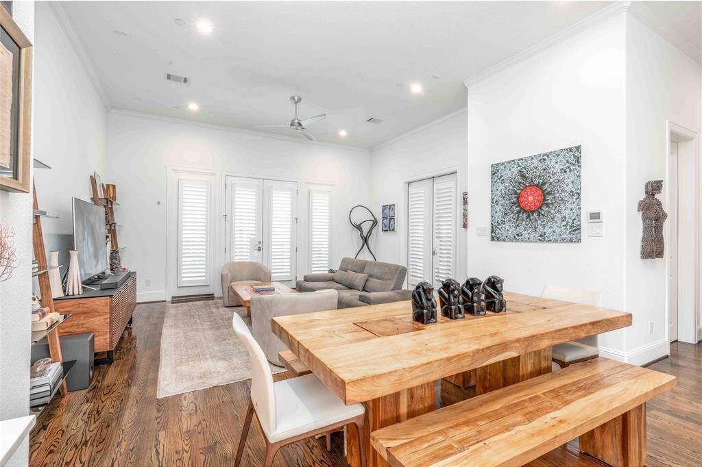 This bright, open-concept living space features hardwood floors, high 12' ceilings and an expansive living room offers ample space for cozy seating, perfect for comfortable living and entertaining.