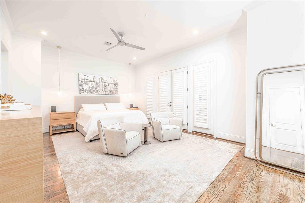 Unwind in your spacious Primary bedroom with custom pendant lighting, warm oak hardwood floors and cozy seating area.