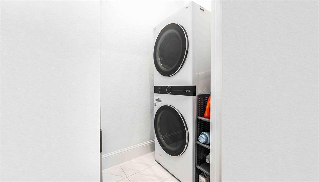 Utility room conveniently located off primary with sleek LG Washer/Dryer
