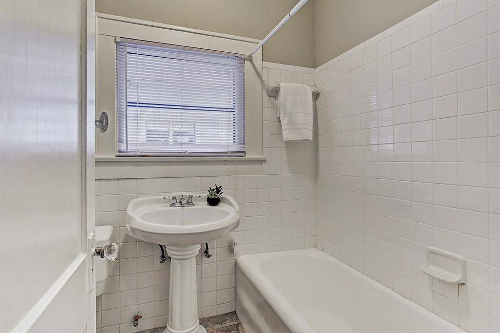 Impeccable full bath down with tile Cast-iron tub & pedestal sink