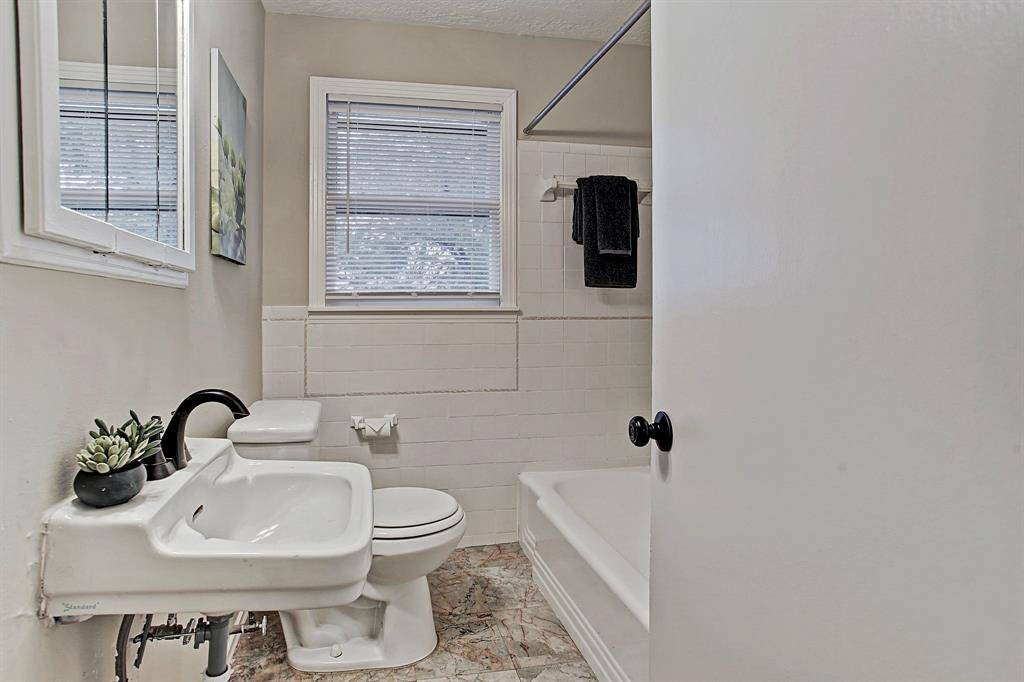 Great bathroom upstairs with custom tile & cast iron Tub