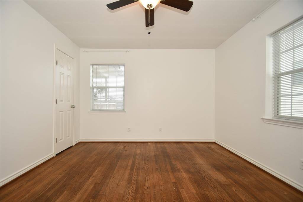 Bright and airy bedroom with hardwood floors and abundant natural light.