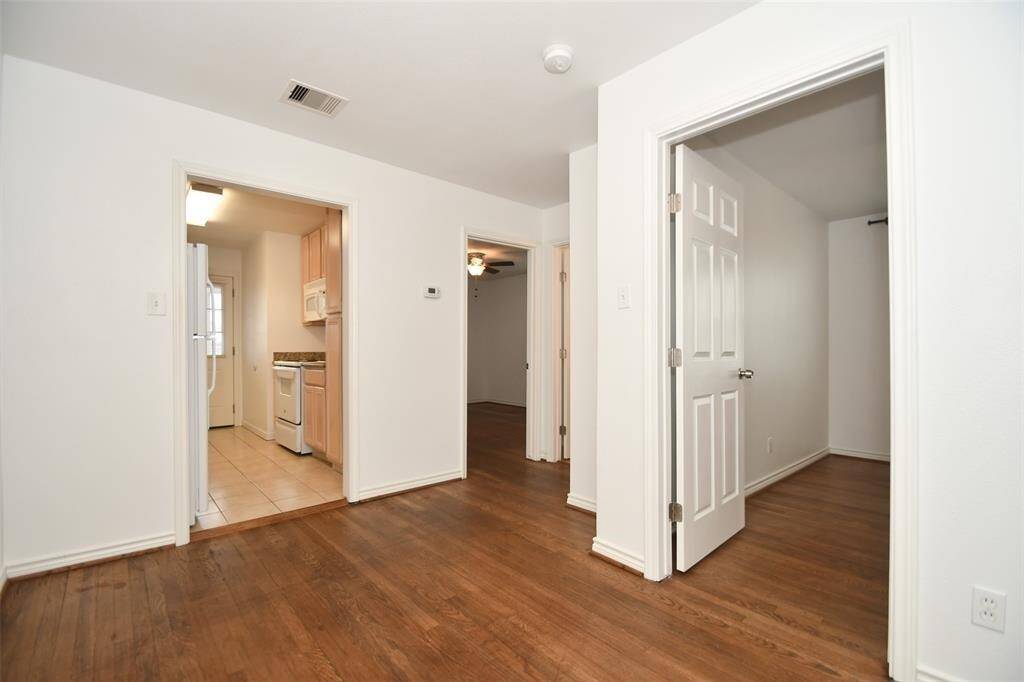 Dining space with gleaming hardwood floors, seamlessly connected to the kitchen for easy entertaining.