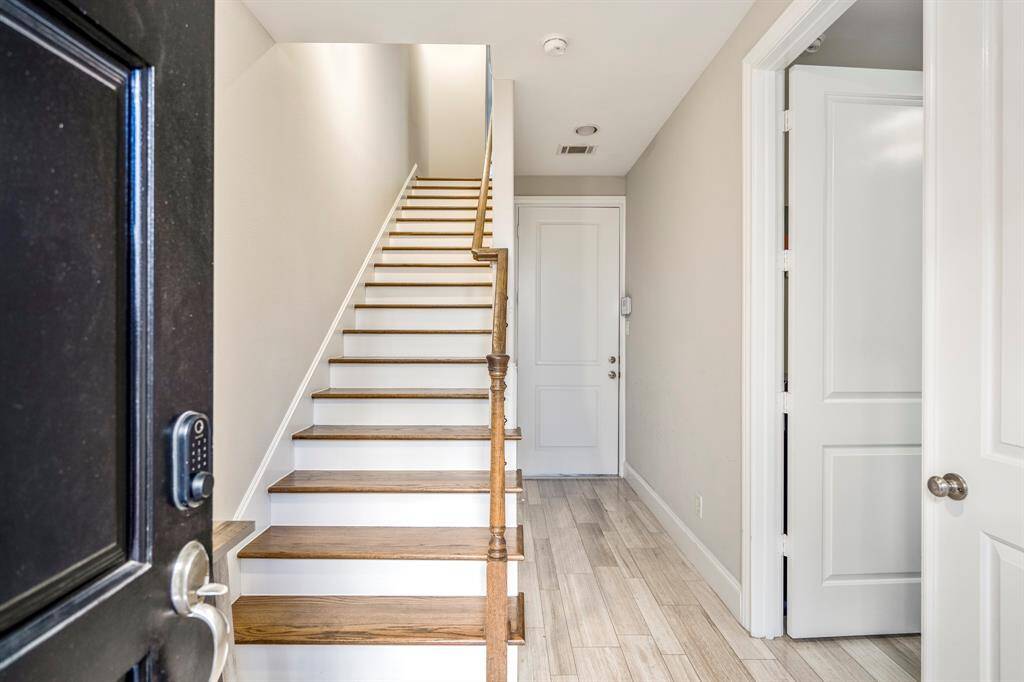 Front door leading into guest room/office on first floor and garage.