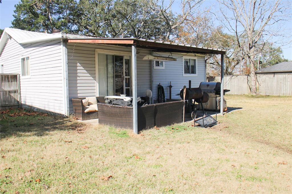Cozy backyard with a covered patio, perfect for outdoor relaxation and grilling.
