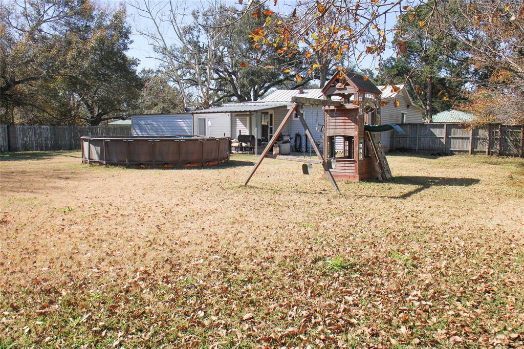 Spacious lawn with privacy fence. Ideal for entertaining or enjoying quiet moments outdoors.