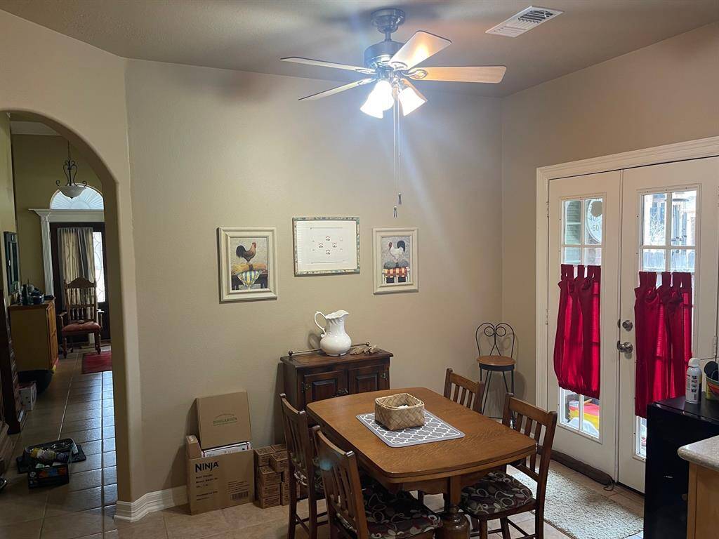 Breakfast area is just off the kitchen. French doors lead to the side and back of the home.
