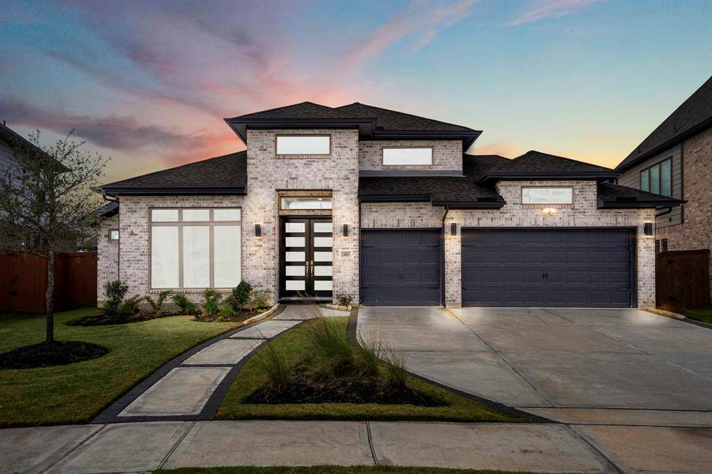 Welcome home to 24515 Green Buffalograss! This modern 1 story home invites you in and sits on a spacious lot with sensational curb appeal, lush landscaping, and modern sidewalk entrance with black paved accents!