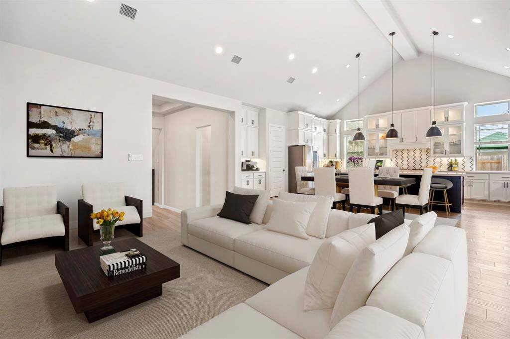 The open concept living room and kitchen makes for a great way to keep the party going and never miss a beat! *This photo has been virtually staged