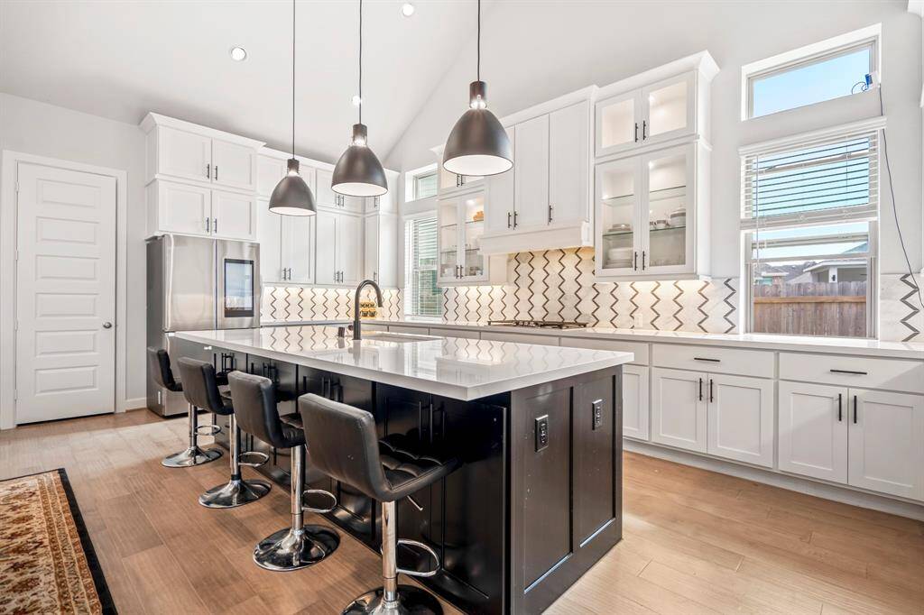 The extra-large kitchen island is perfect for conversation or that much needed space to lay out your party spread for everyone to enjoy! This kitchen conveniently connects to the dining area and living room for easy entertaining!