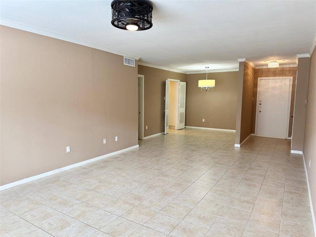 Living area with ceiling fan from window looking toward entry hall and dining area