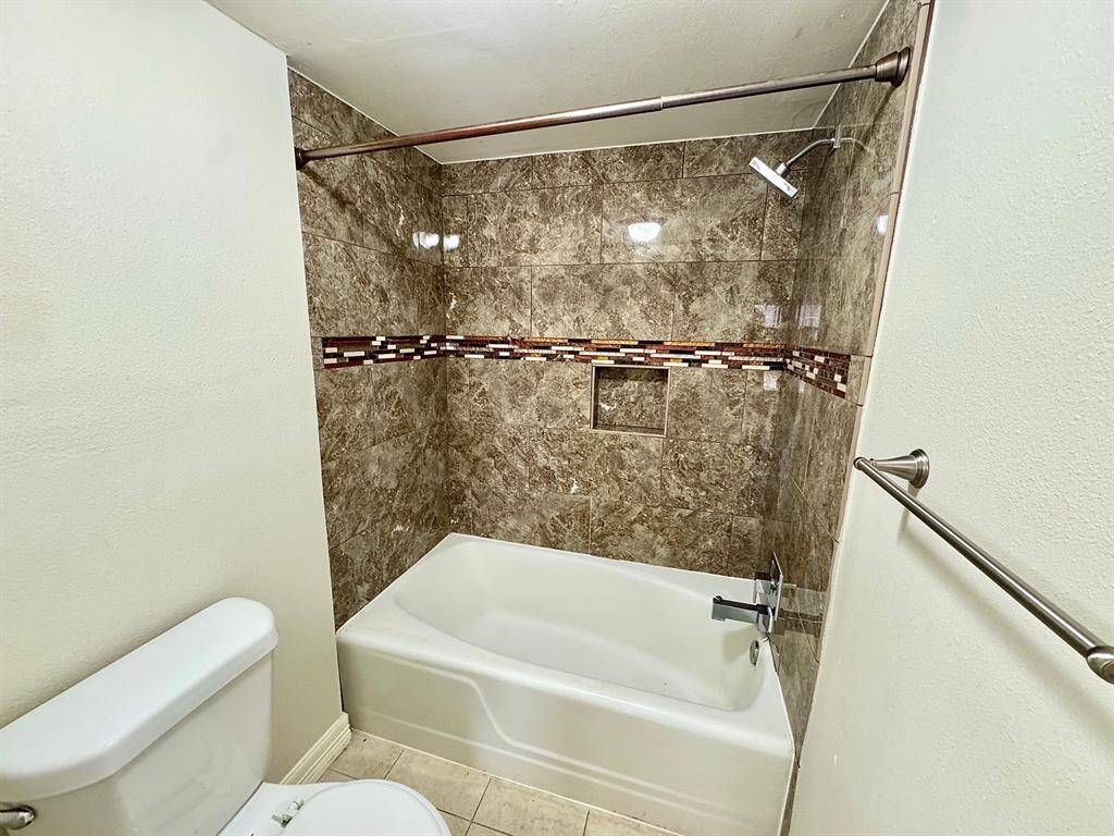 Hall bath with toilet is in its own room with door for privacy.