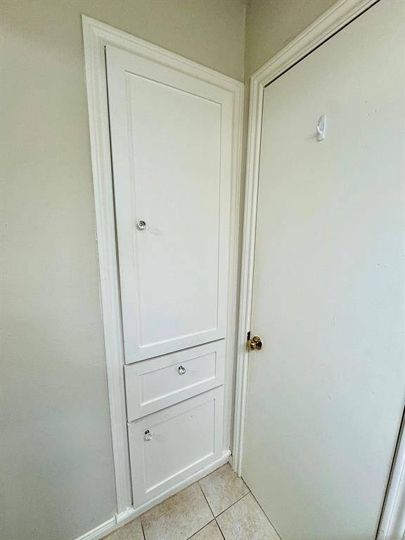 Additional storage cabinet in hall bath.