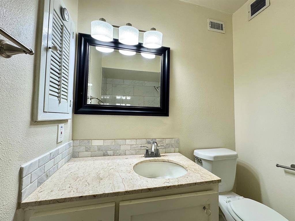 Primary vanity with wall cabinet.