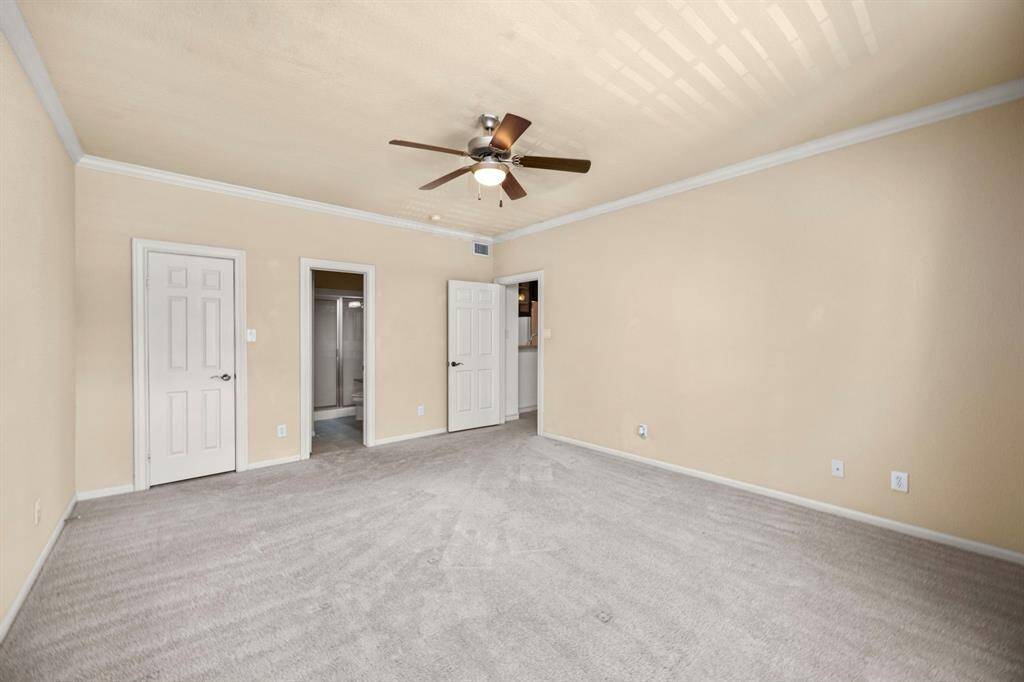 Another view of Primary bedroom. Walk-in closet and ensuite bathroom.