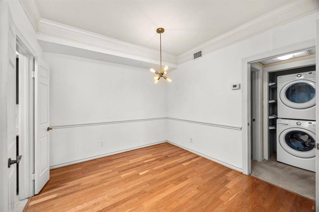 Dining room features updated flooring, crown molding, and a modern light fixture.