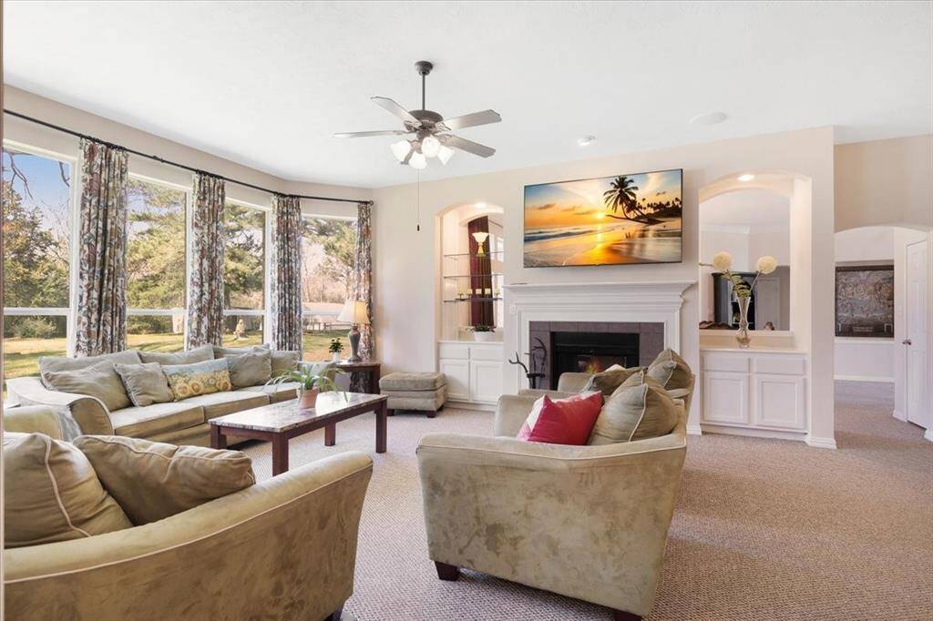 Living room features lots of natural lighting as well is built in surround sound, fireplace and berber carpet.