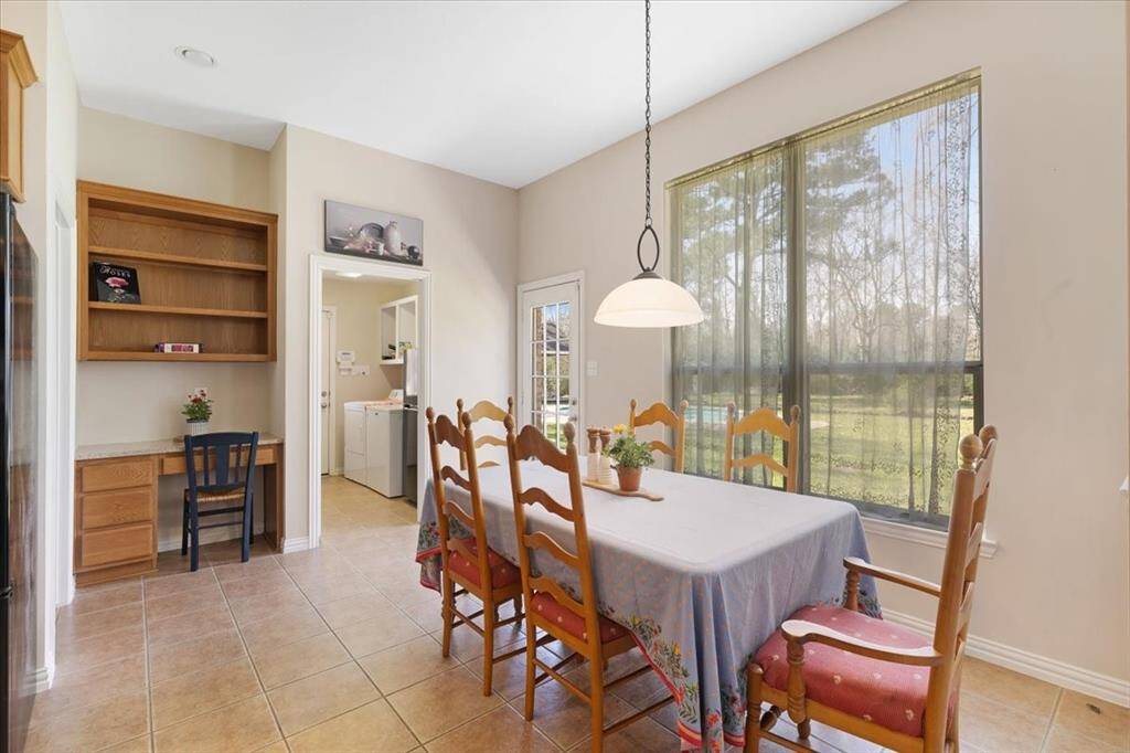 The breakfast room is just off the kitchen. Please note the laundry room is inside the home and has space for another small refrigerator. The kitchen also includes a small office nook.