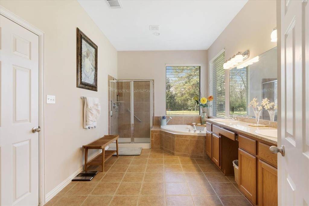 The primary bathroom has dual sinks. jetted tub and a stand up shower.