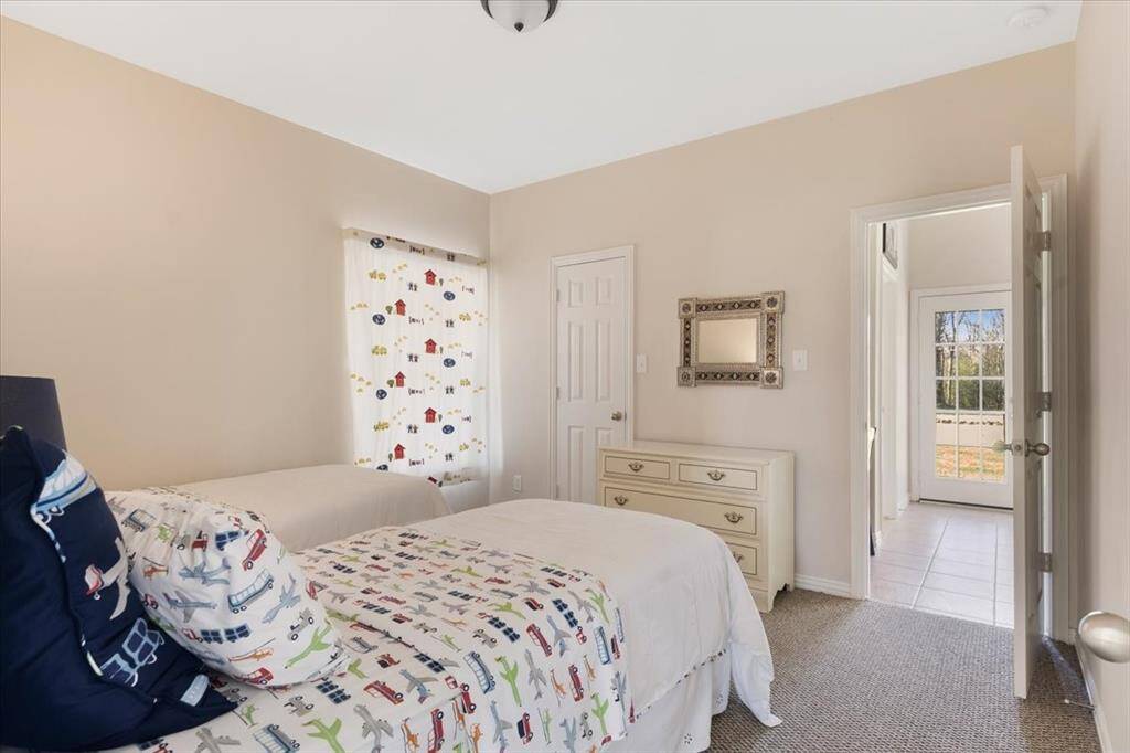 Bedroom number three also features a door that leads to the kitchen. The seller wanted access to the secondary bedrooms as you enter the home without having to walk around the kitchen.