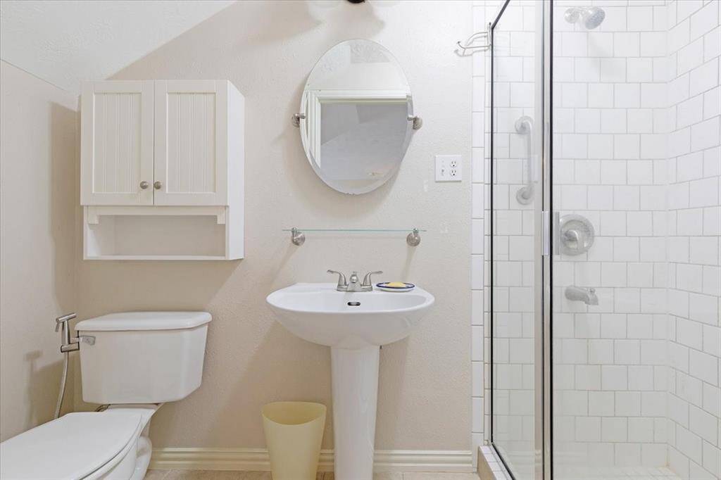 This is a full bathroom located upstairs in the game room.