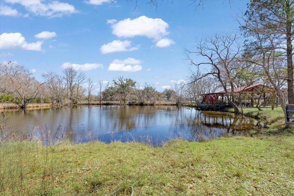 Pond located on the property has a gazebo and a deck over the edge of the water.