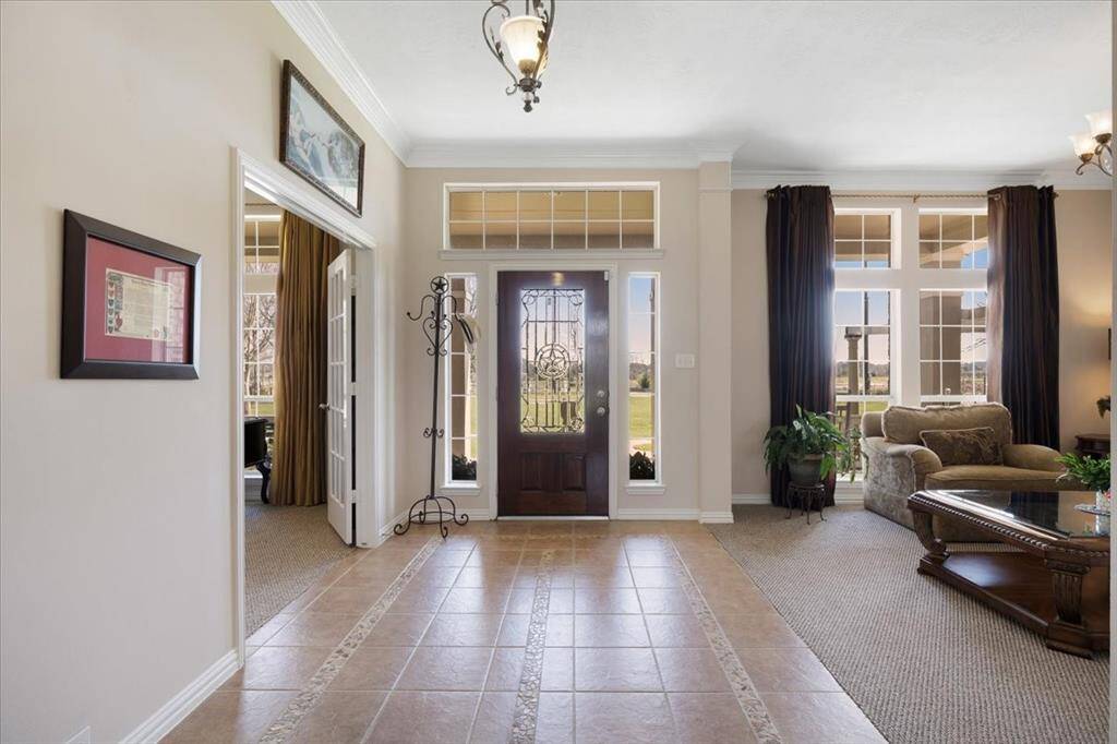 The tile entry features high ceilings and a formal living immediately to the left upon entry
