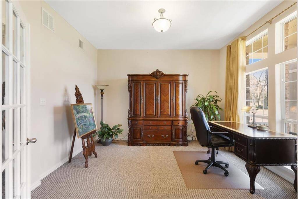 Study with french doors immediately to the right upon entering the home