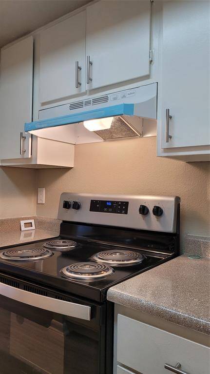 Partial view of remodeled kitchen and new stove