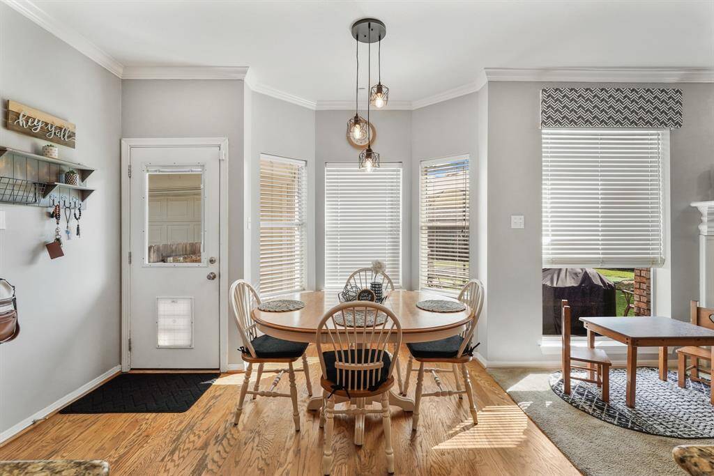 A charming breakfast nook with a bay window offers a picturesque view of the backyard.