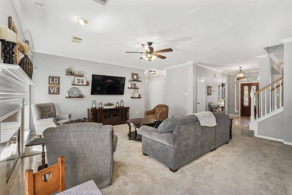 A spacious, welcoming living room offers a comfortable space to relax with friends and family. This photo is staged for photo purpose.
