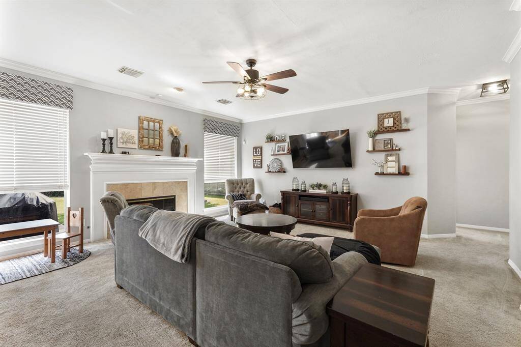 Enjoy the fireplace and decorative mantle between two large picture windows. This photo is staged for photo purpose.