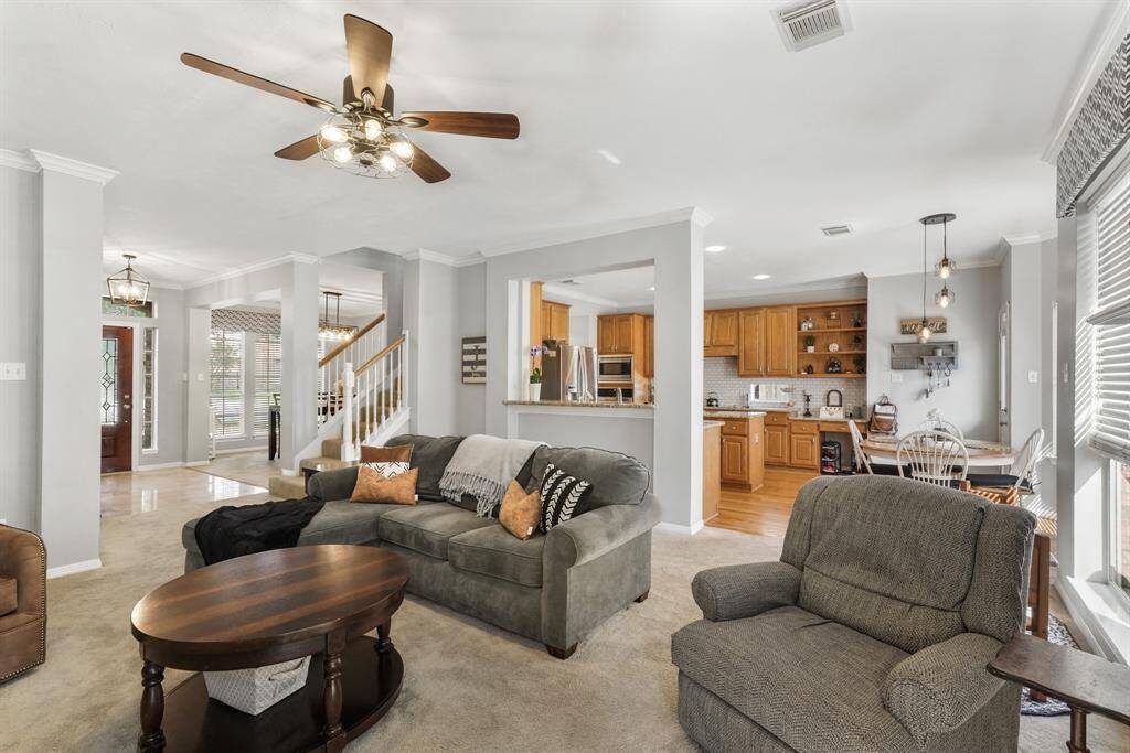 From the corner of the living room, you'll have a terrific view of the kitchen, formal dining room, and the staircase. This photo is staged for photo purpose.