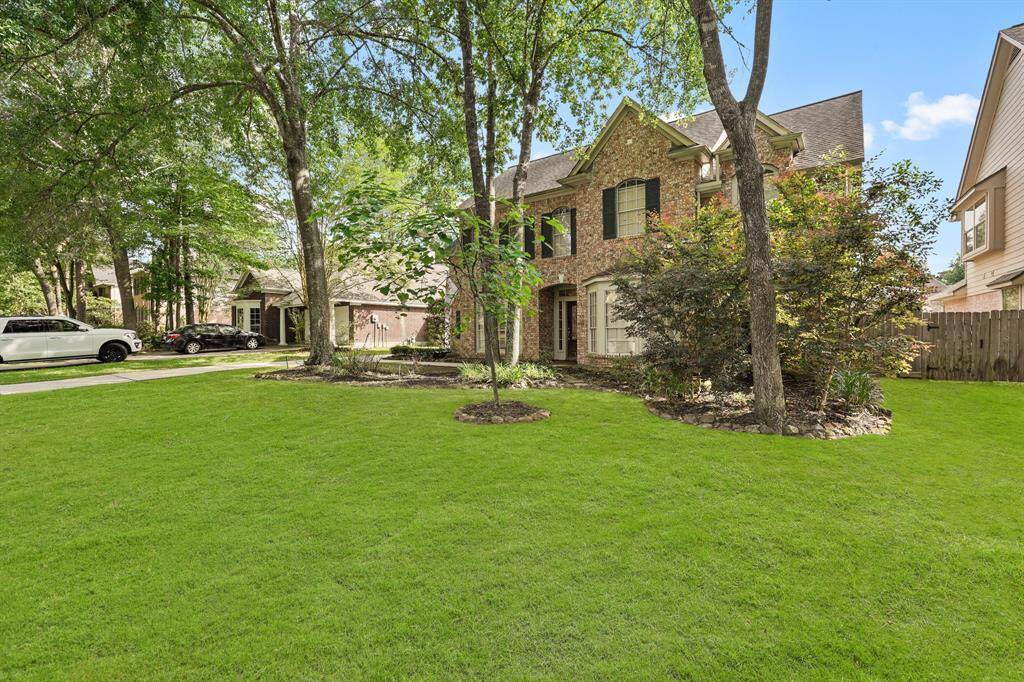 Experience the charm of this home, nestled beneath the shade of majestic, mature trees.