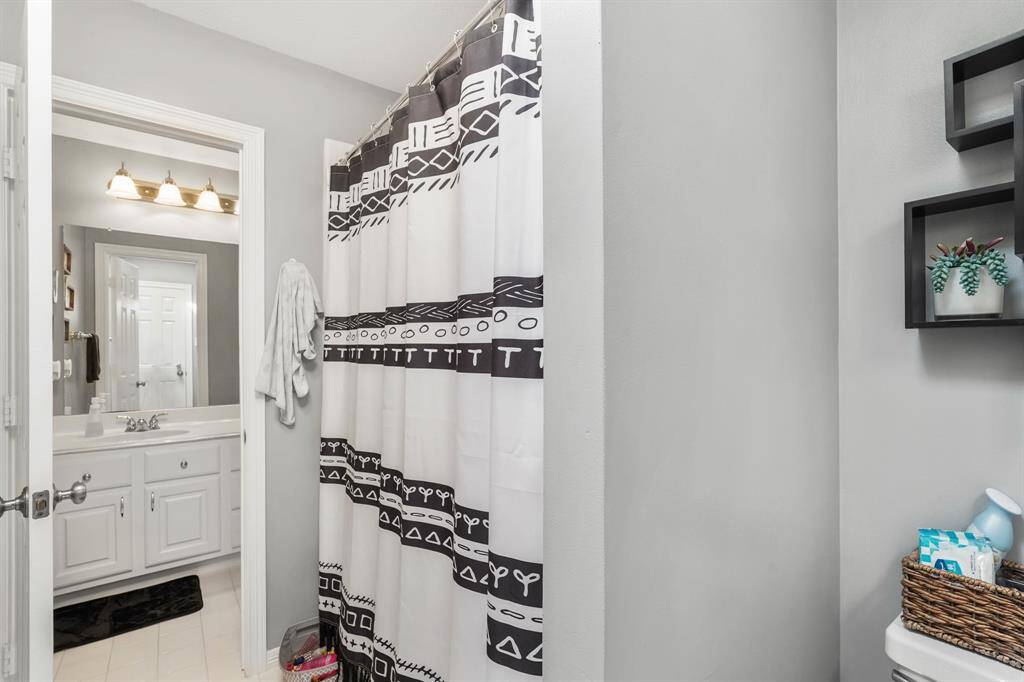 A secondary bathroom upstairs features a tub and shower combination.