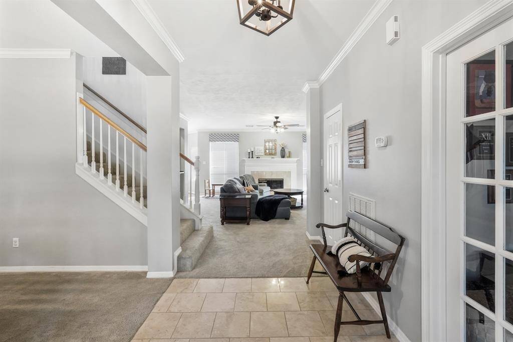 Experience the perfect blend of wood, tile, and carpet that elegantly define each space. Upon entry, a formal dining room greets you to the left, while a cozy study awaits on the right.
