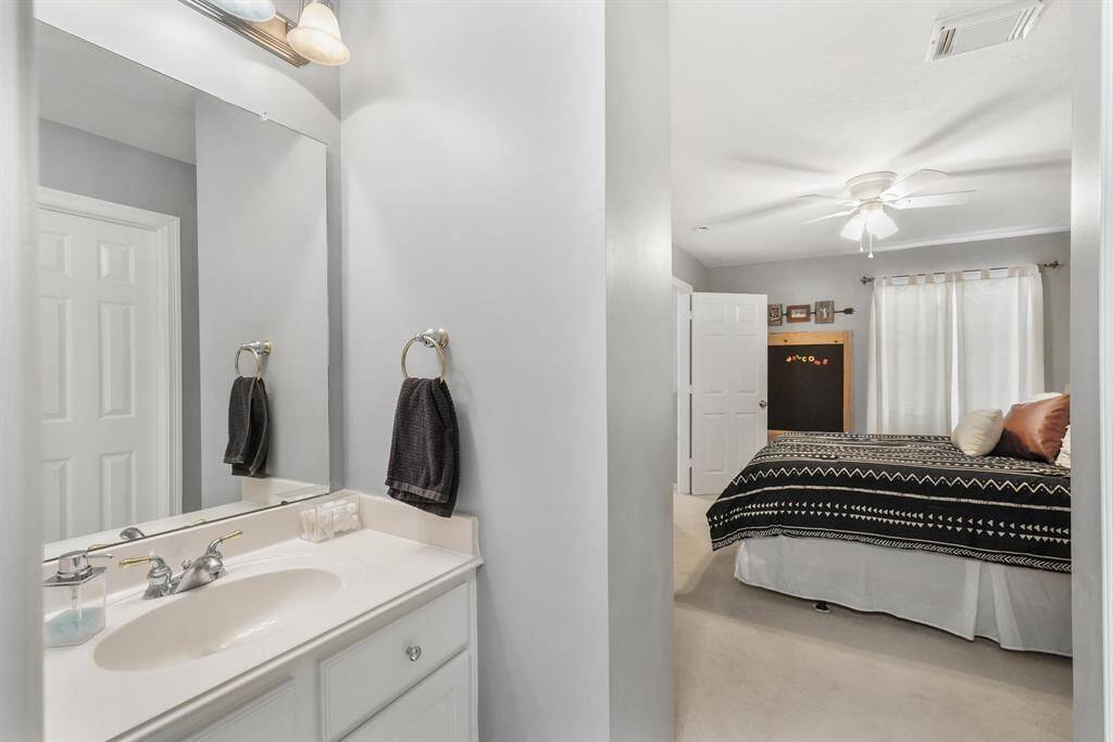 Bedroom 4's private bath includes a small vanity.