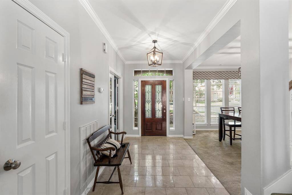 Elegant entryway featuring a stunning front door with decorative glass inlay.