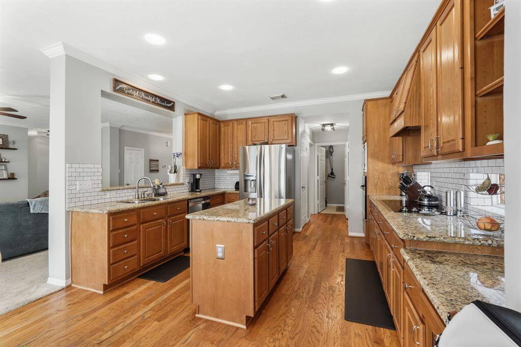 This bright, spacious kitchen seamlessly connects to the dining room, offering convenience and style for effortless entertaining.