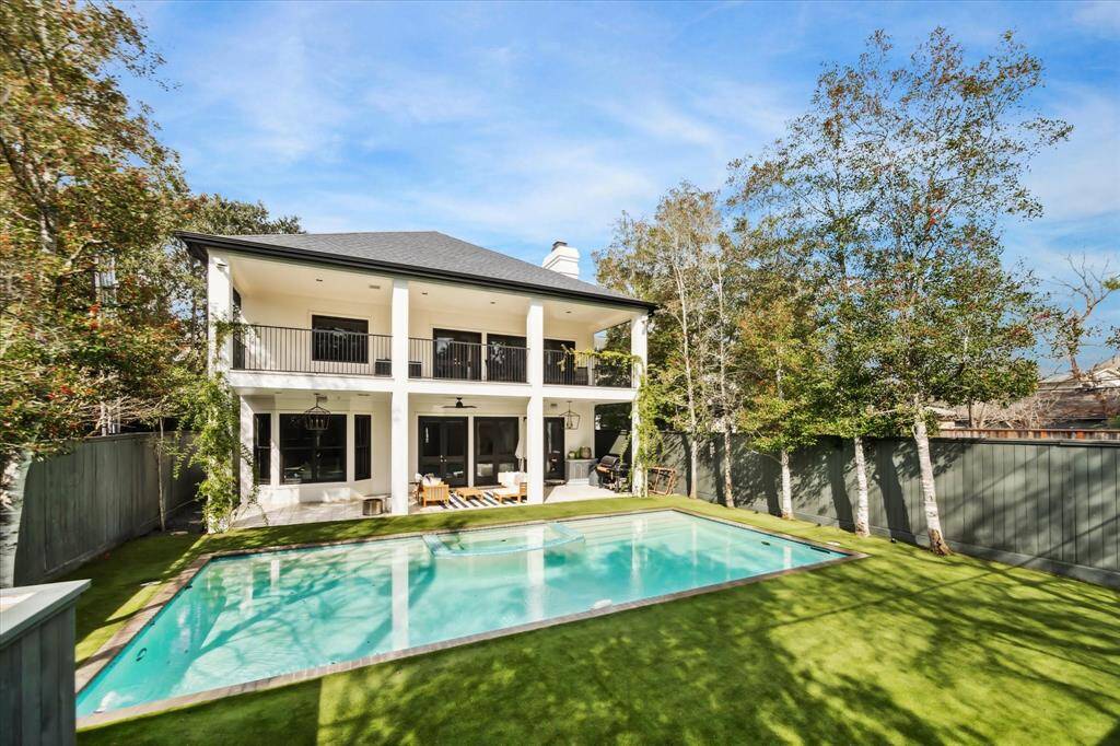 The fully turfed backyard offers low-maintenance luxury, complete with a mosquito misting system and a sprinkler system, all surrounding a sparkling pool for ultimate outdoor enjoyment.