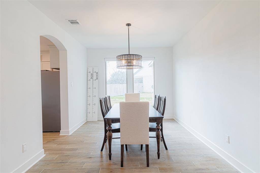 The formal dining room connects seamlessly to the island kitchen.