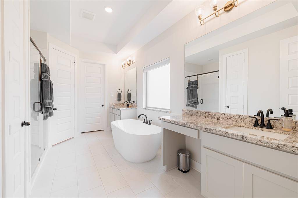 An ensuite bath with dual sinks and a soaking tub.