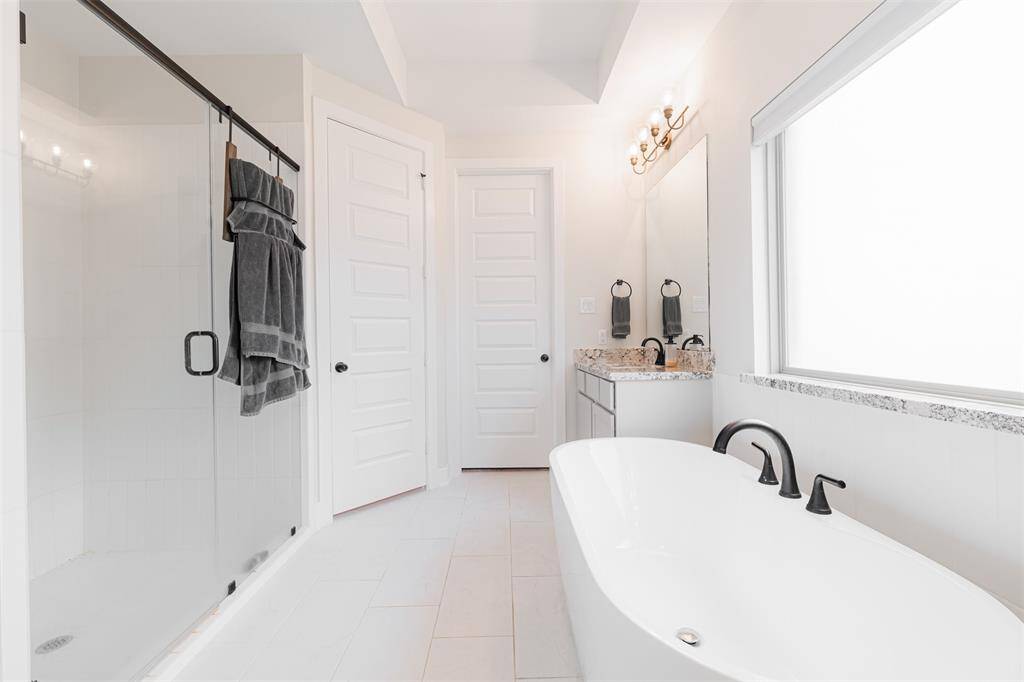 Primary bath also has a separate walk-in shower and large walk-in closet.