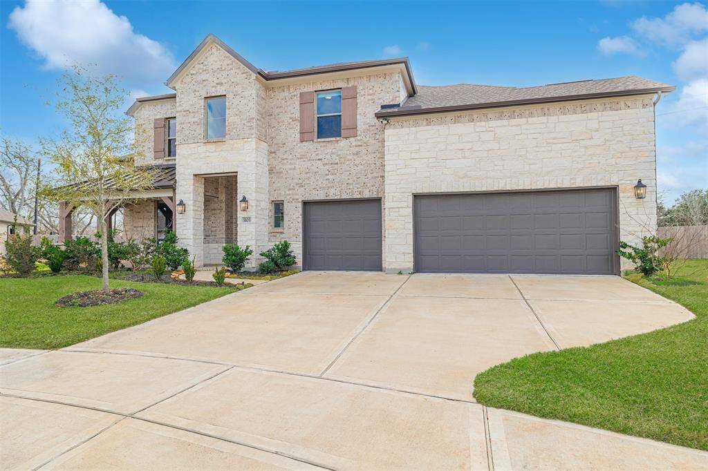 This home also features a 3-car attached garage and includes a Tesla EV charger in the garage.