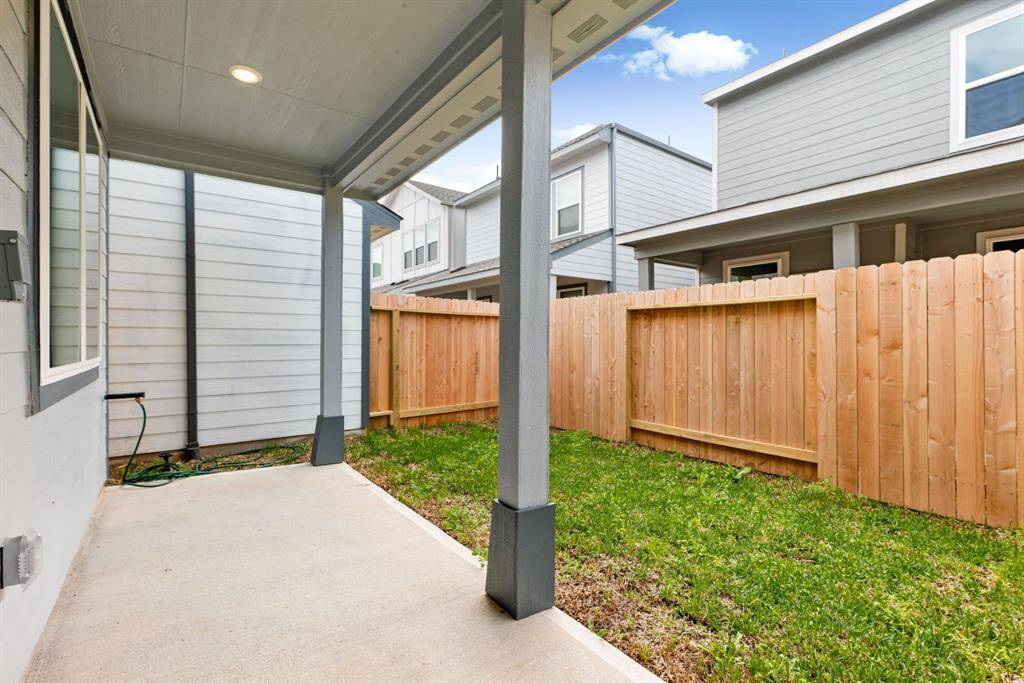 Step outside to a private, fenced backyard featuring a covered patio—perfect for outdoor dining, relaxation, and entertaining.