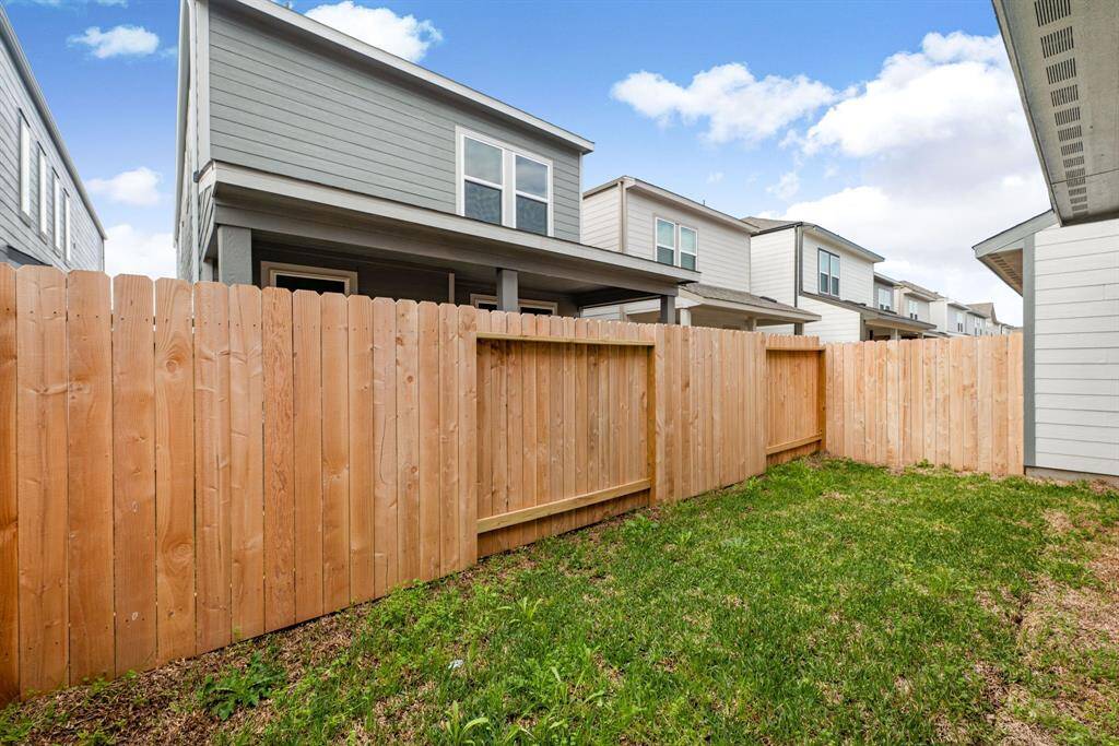 A seamless extension of your living space, this fenced backyard with a covered patio is perfect for both cozy gatherings and outdoor fun.