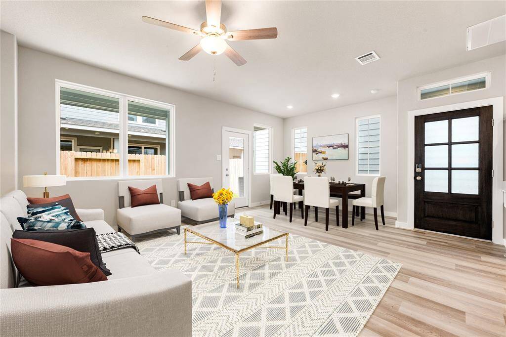 Gather the family and guests together in your lovely living room! Featuring soaring high ceilings, recessed lighting, dark stained ceiling fan, custom paint, gorgeous wood style floors and large windows that provide plenty of natural lighting throughout the day. *Virtually Staging