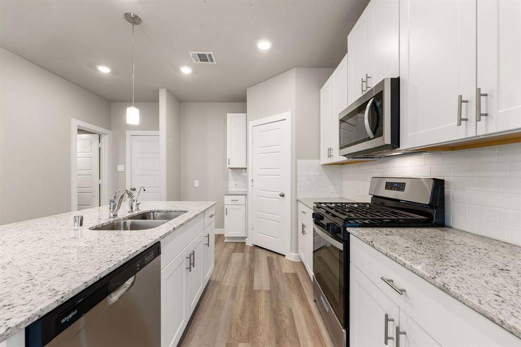 Any chef's dream, this stunning kitchen is perfect for everyday life as well as entertaining family and friends! Extra large kitchen island is perfect for conversation or that much needed space to lay out your party spread for everyone to enjoy! Large windows provide lovely views of your backyard and plenty of natural lighting throughout the day.