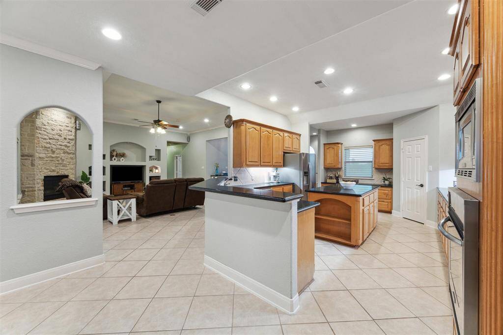This view of the kitchen shows you the wrap around breakfast bar where you can have additional seating.